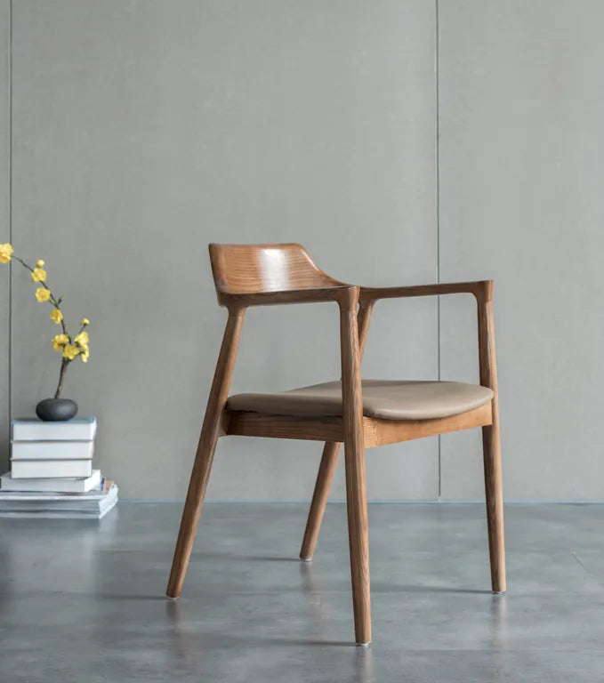 This versatile chair is made of North American ash and vegan leather. Lenox Tan seat and Walnut finished frame are also options.