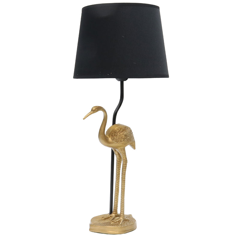 A simply styled black shade is lined in gold. The light reflects downwards highlighting the intricate detail of the crane base. Measuring 59cm in height. Available now at Chambers Design.