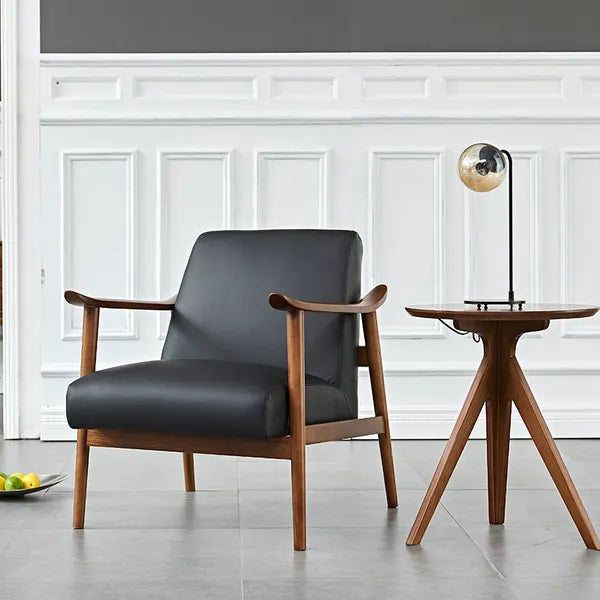 A sophisticated and charismatic statement chair, expertly crafted from leather and North American ash, with Walnut finish.  Sculptured arms and wide, plush seat.