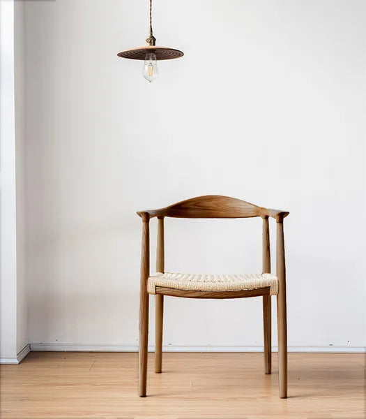 The elegant design and beachy sand-dollar shape are sure to get everyone's attention at the dinner table. For comfort and durability, a natural woven rope seat is combined with a sturdy North American ash frame finished in walnut.