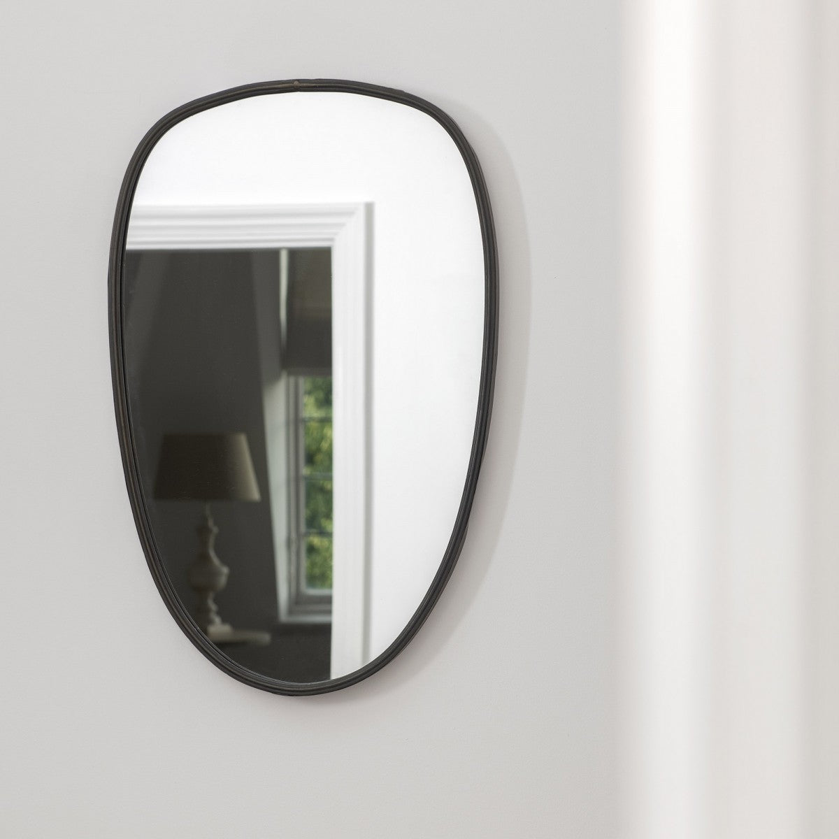 Stylish oval shaped mirror with black trim from Chambers Design